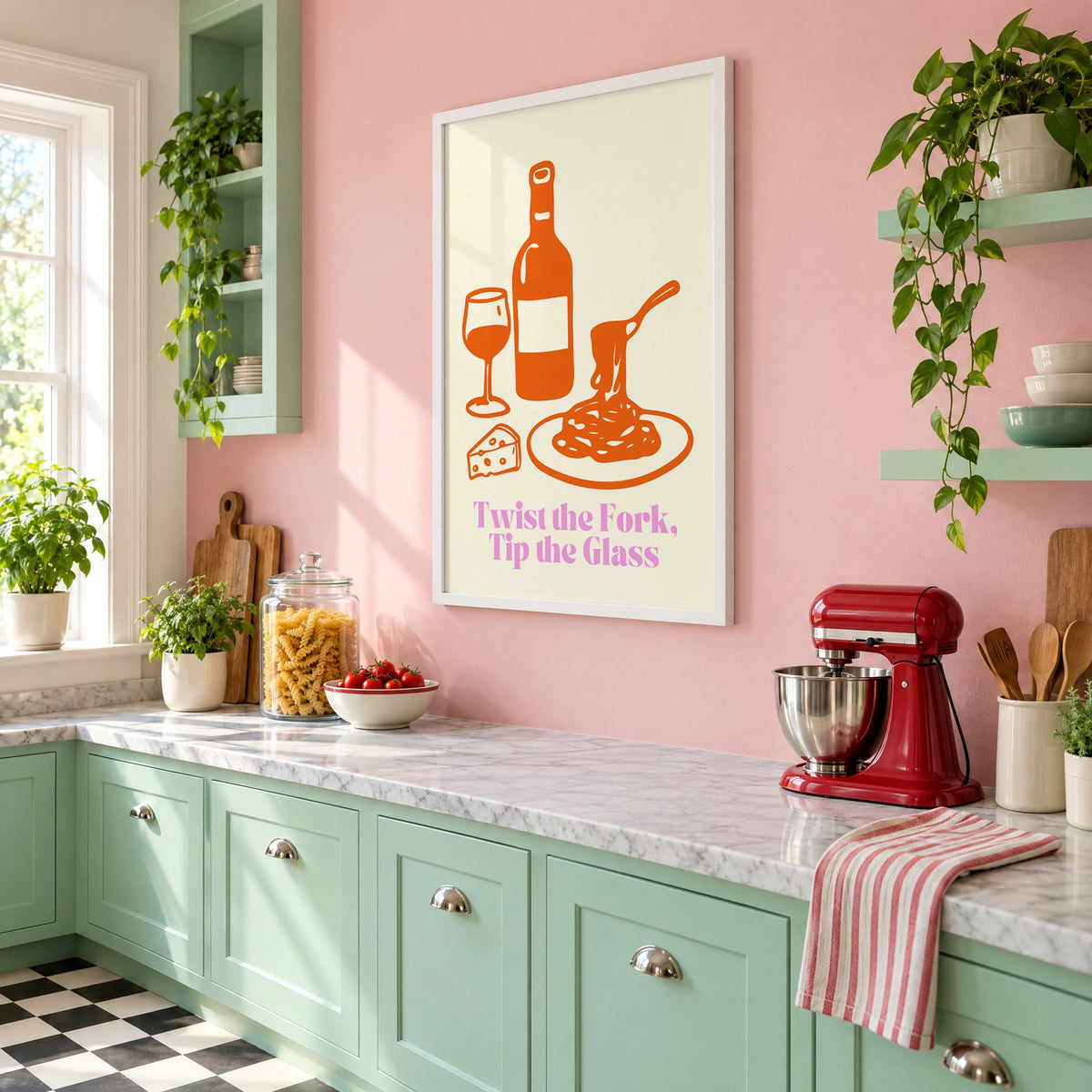 Twist the Fork, Tip the Glass wine and pasta print in a white frame on a pink wall above mint green cabinets in a retro kitchen, seen at an angle