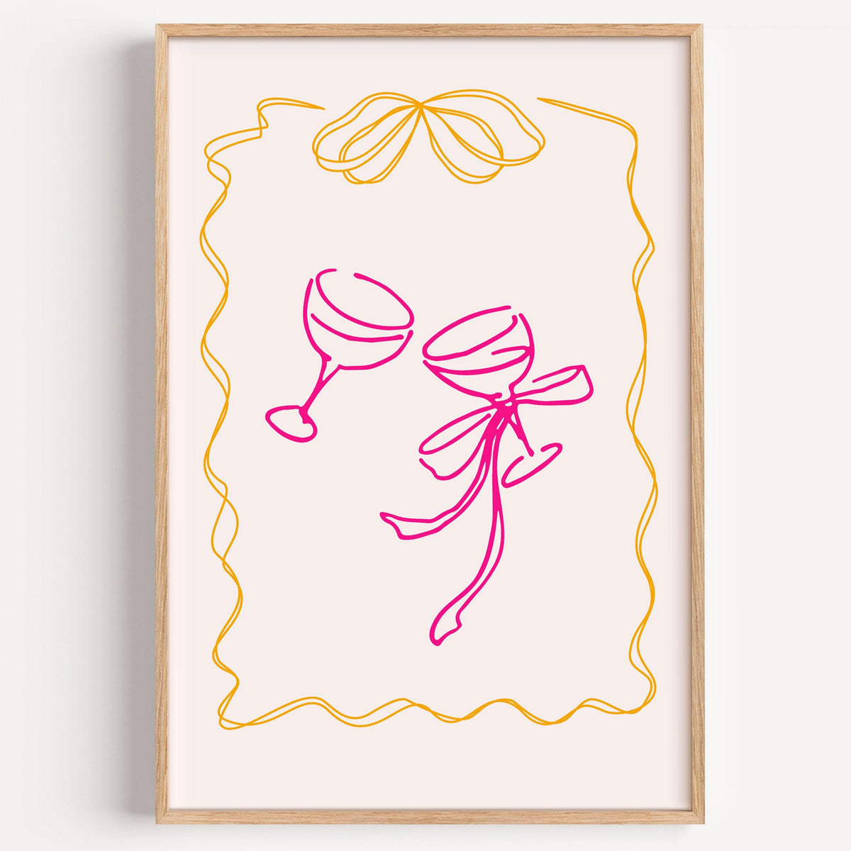 Two coupes pink bow ribbon frame print in a light oak frame on a plain white wall