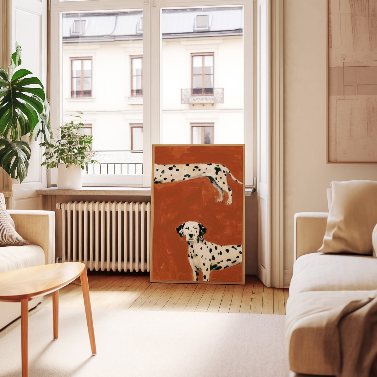 Spotted dog print in an oak frame leaning below tall French windows