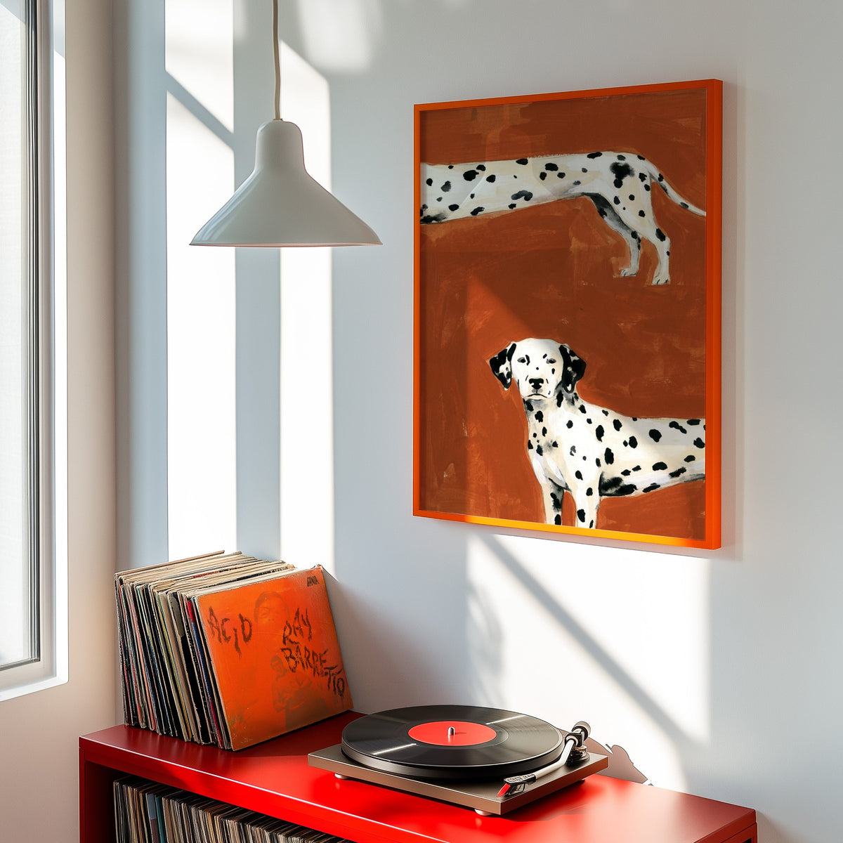 Spotted dog print shown in an orange frame above a red record cabinet and turntable