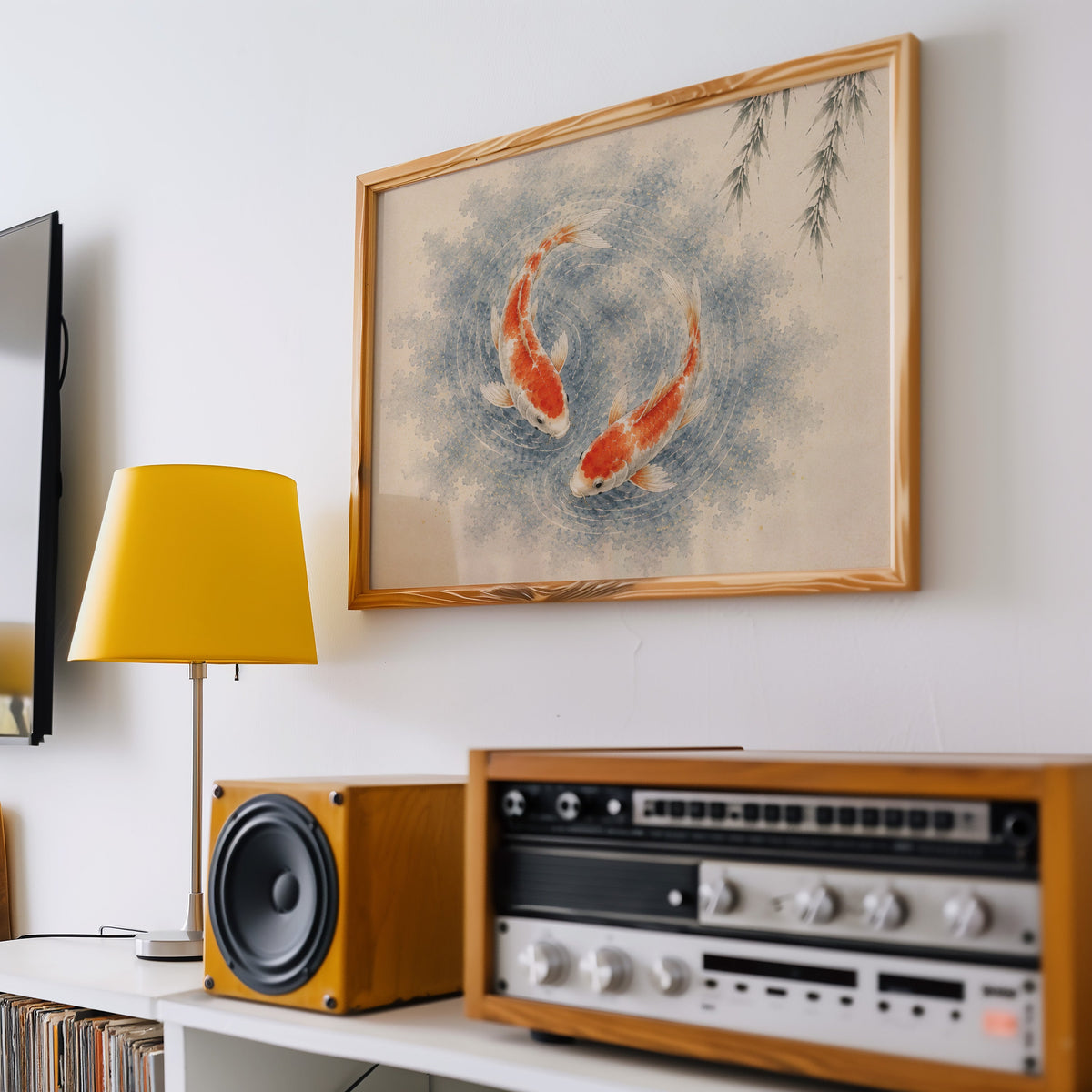 Two koi circling under a willow print in a pine frame above a vintage stereo and a yellow table lamp