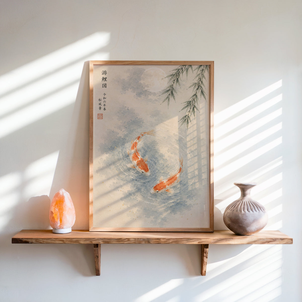 two koi with willow and moon print in an oak frame on a live-edge wall shelf with a salt lamp and clay vase