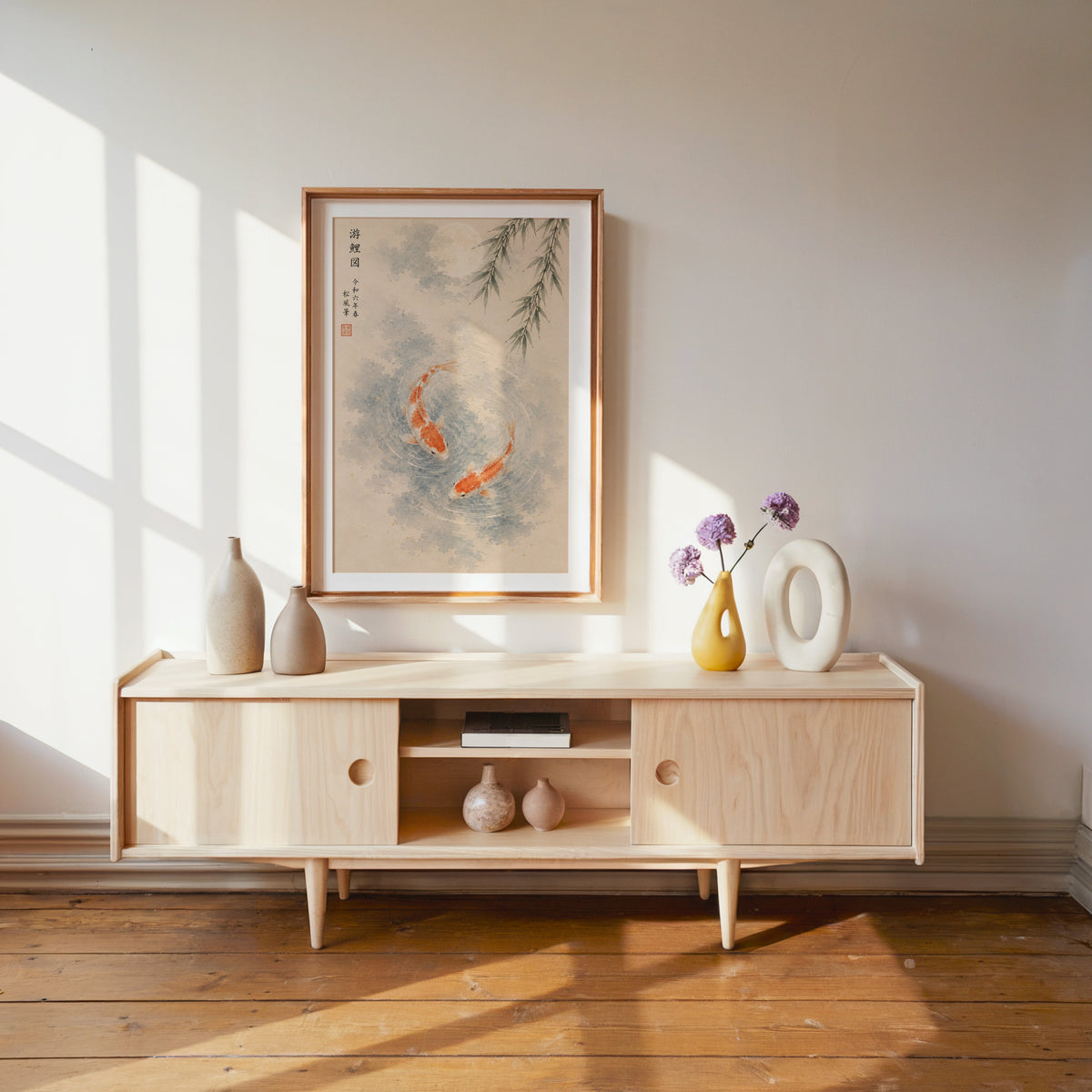 two koi with willow and moon print shown in a wood frame with a white mat above a pale wood media console