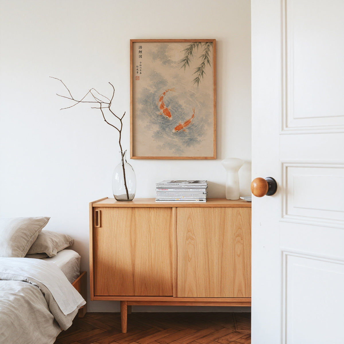 two koi with willow and moon print in an oak frame above an oak sideboard in a bedroom with linen bedding