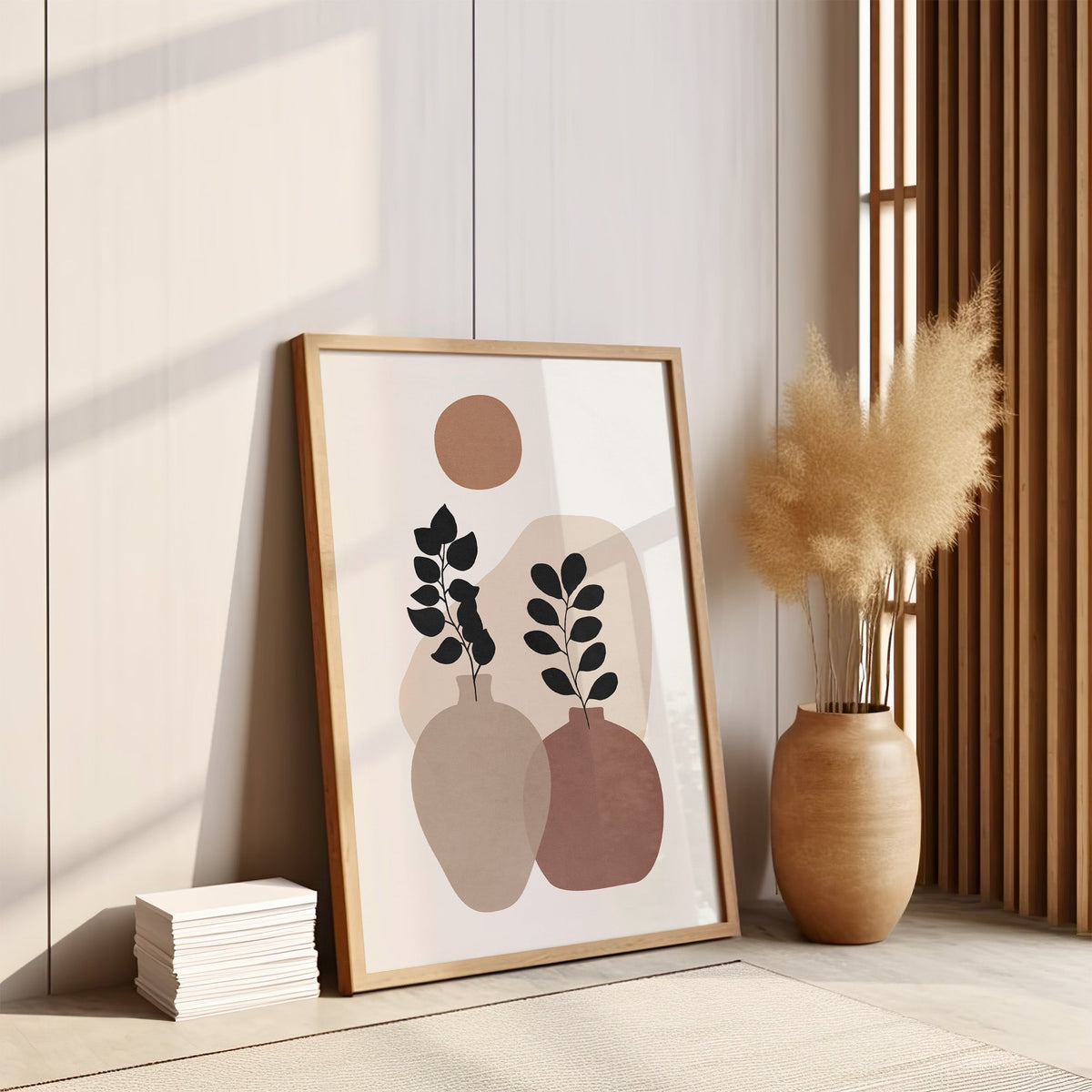 Two vases and terracotta sun abstract botanical print in an oak frame leaning on the floor by pampas grass and a wood slat screen