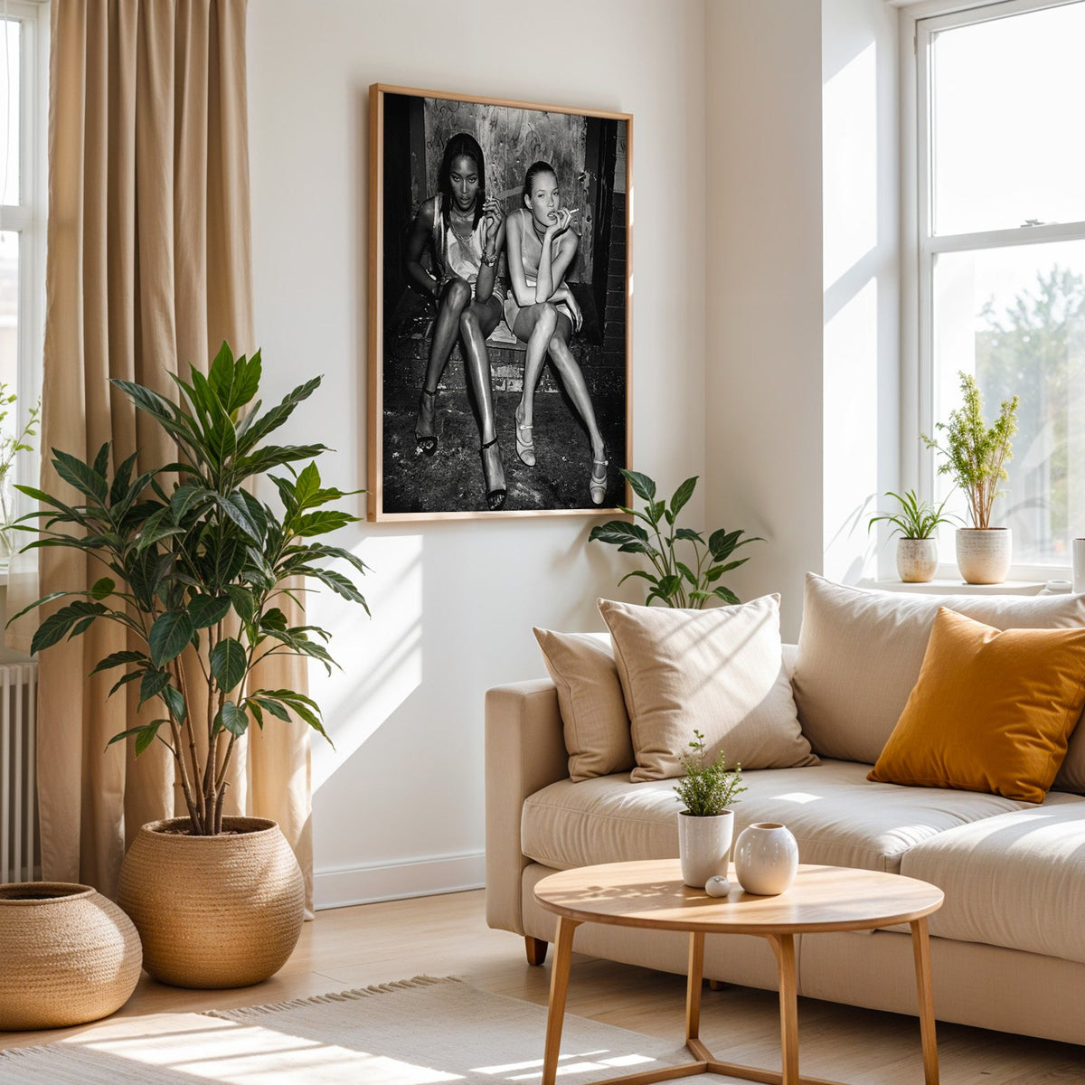 Two women seated on brick doorway steps print in an oak frame above a cream sofa beside woven planters
