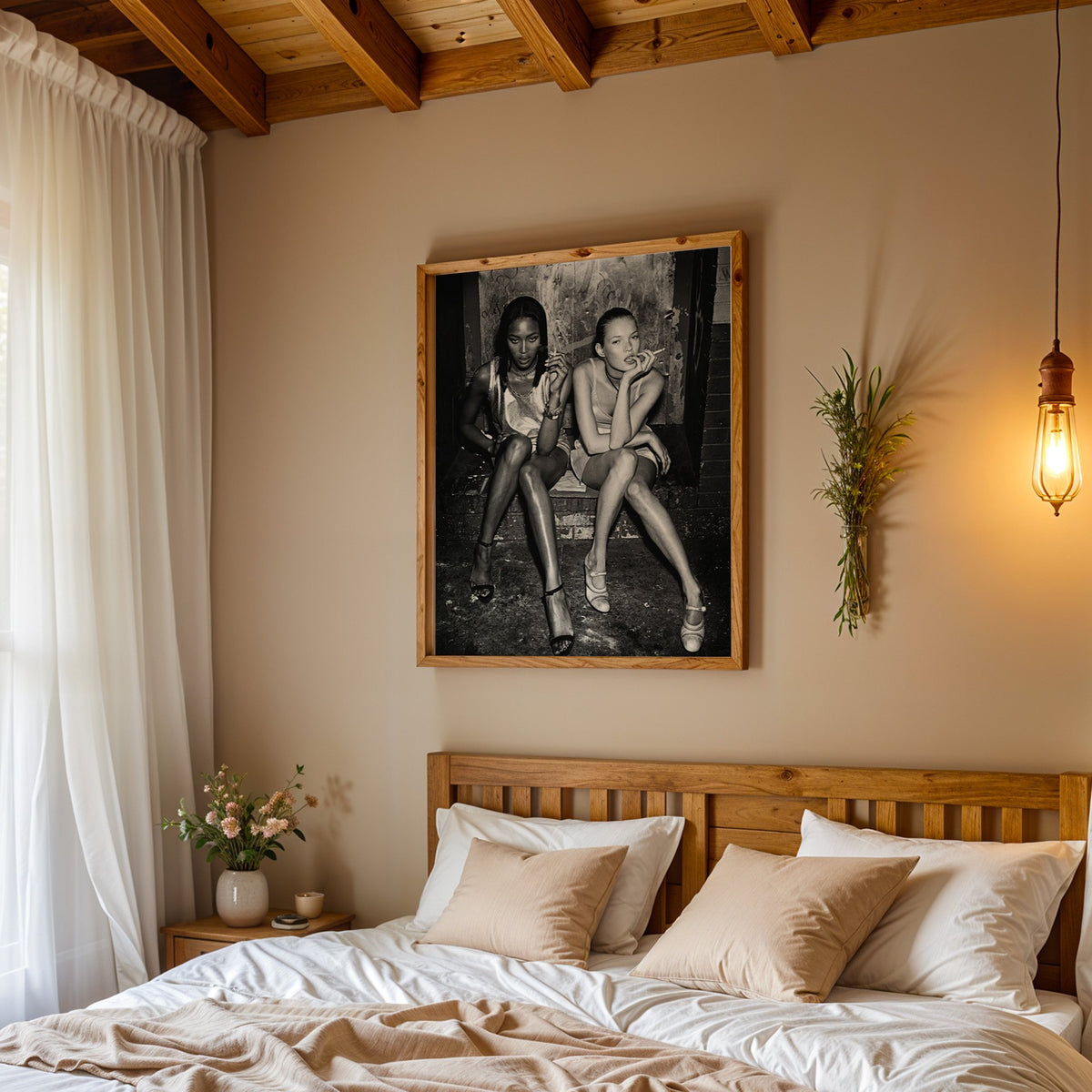 Two women seated on brick doorway steps print in a pine frame above a wood headboard bed under a pendant bulb