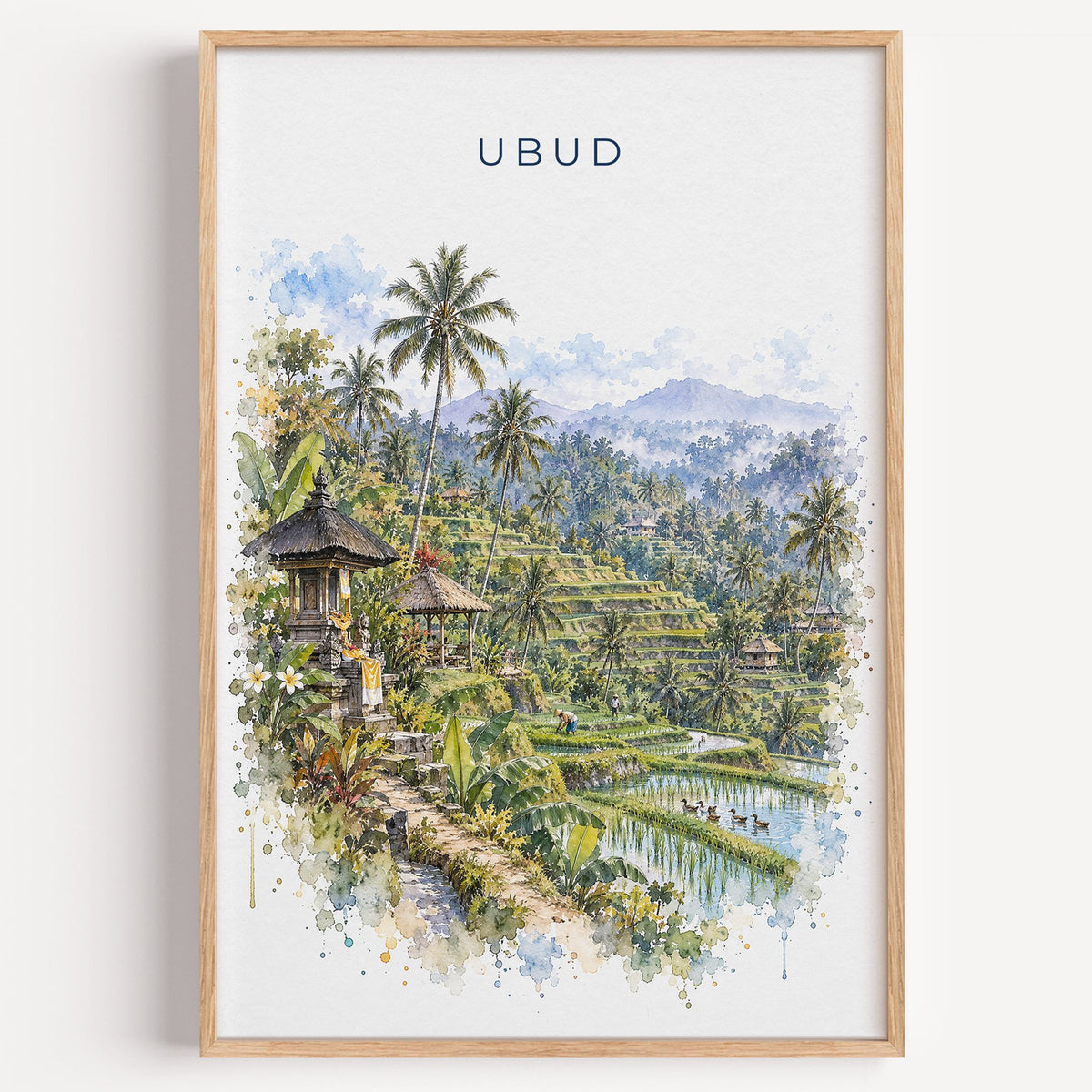 Ubud watercolor print in a light oak frame on a plain white wall