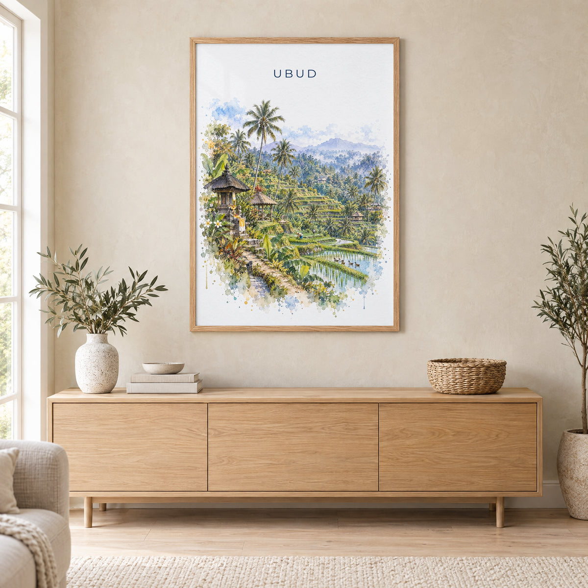 Ubud watercolor print in an oak frame above a light wood sideboard in a Scandinavian living room