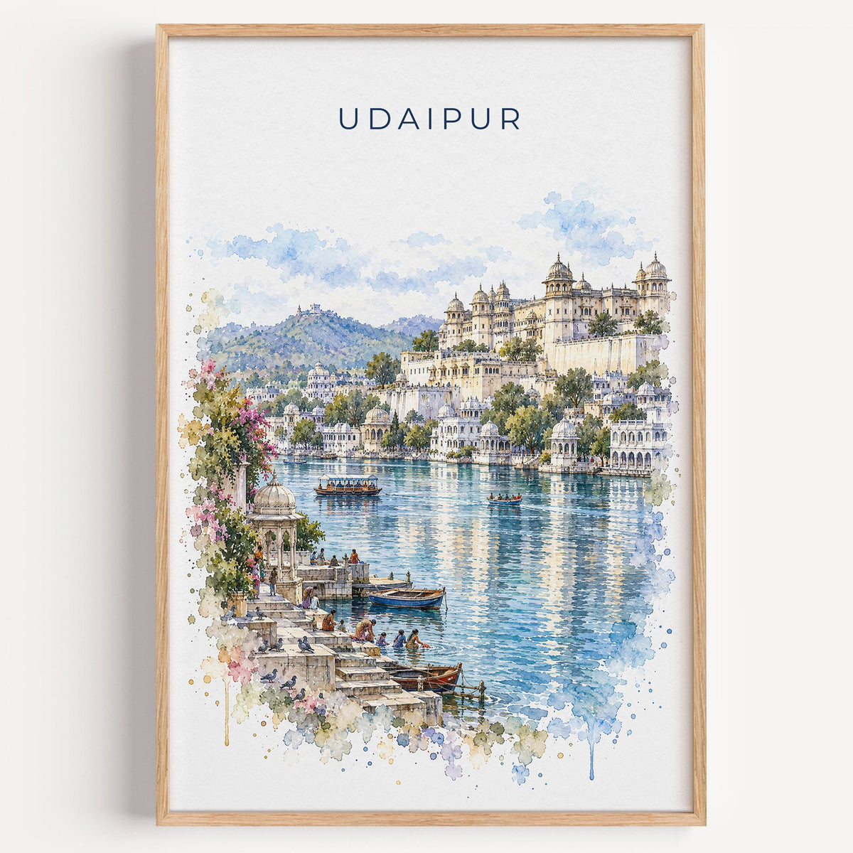 Udaipur watercolor print in a light oak frame on a plain white wall
