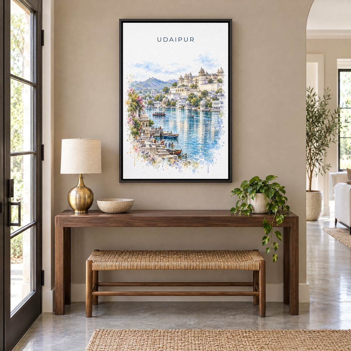 Udaipur watercolor print as a black floater canvas above a walnut console and woven bench in an entryway
