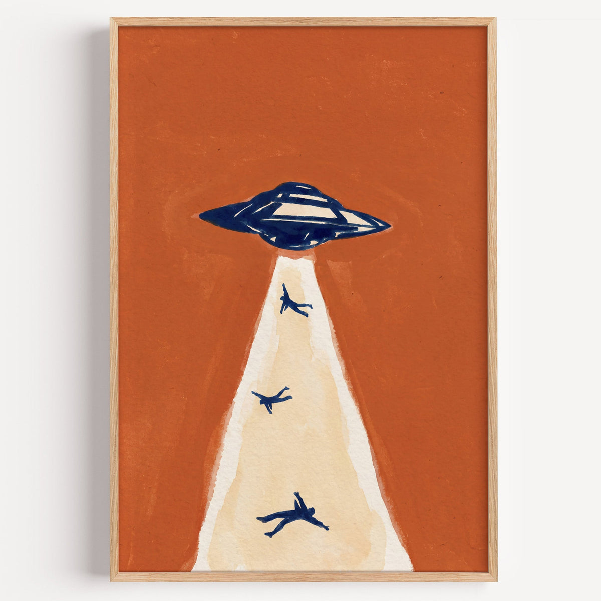 UFO abduction print in a light oak frame on a plain white wall