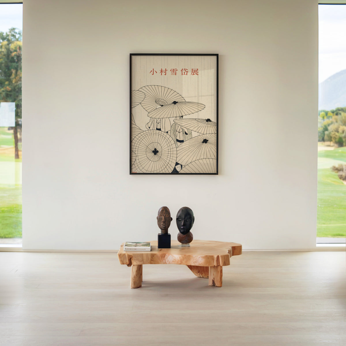 paper umbrellas in the rain line art print in a black frame above a live-edge wood coffee table between garden windows