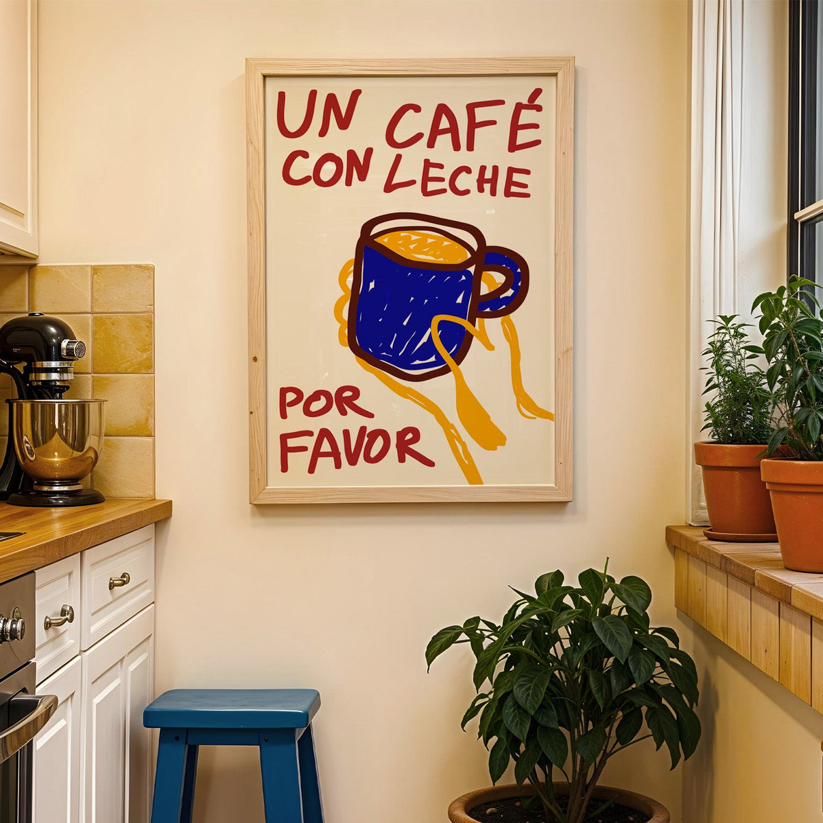 Un cafe con leche print in a wood frame on a yellow tiled kitchen wall