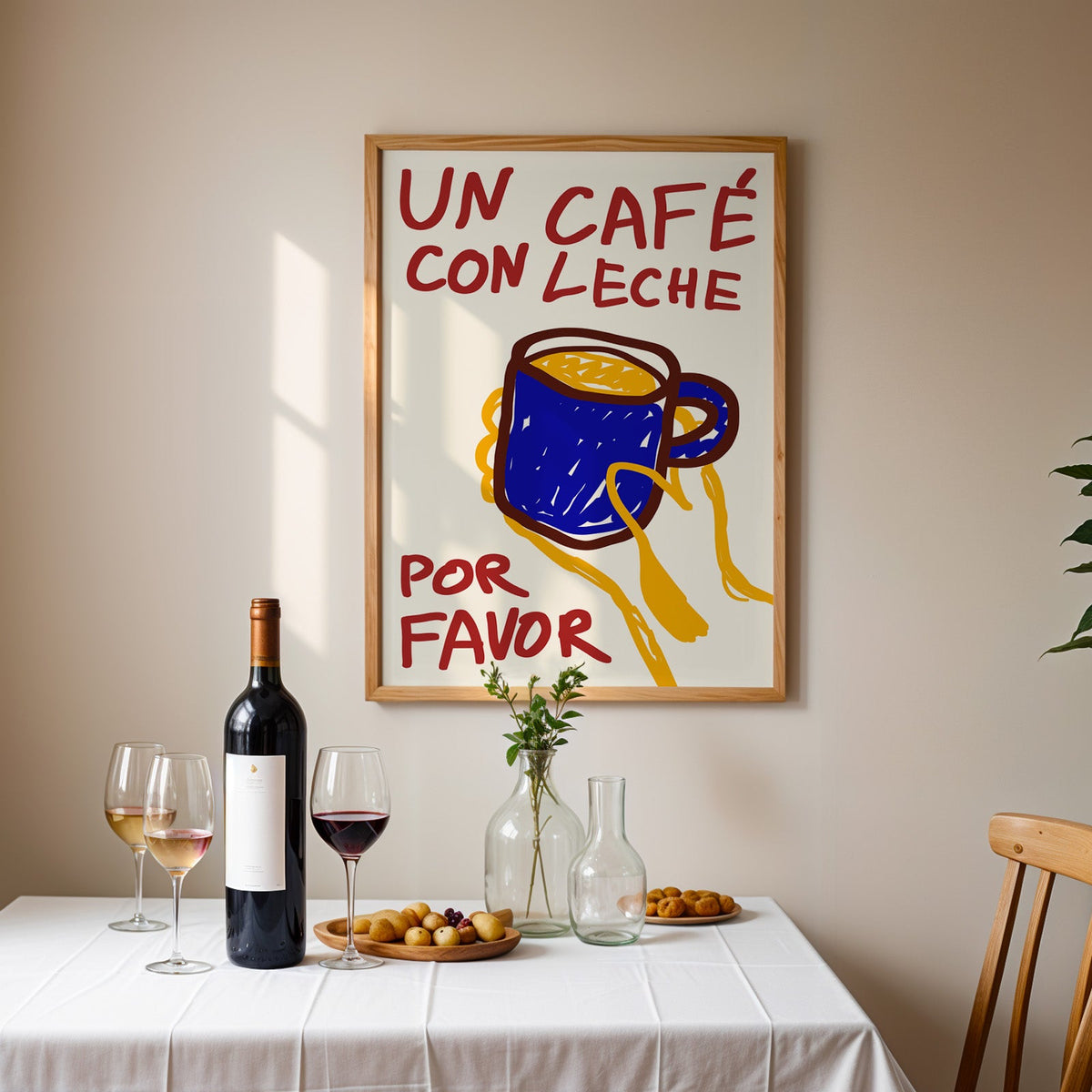 Un cafe con leche print in an oak frame above a table laid with red wine