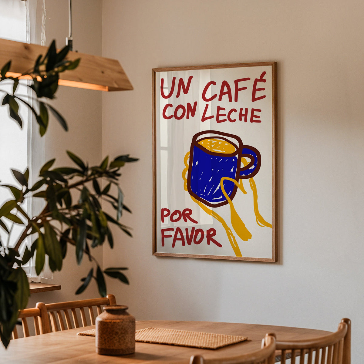 Un cafe con leche print in a walnut frame above a table beside an olive tree