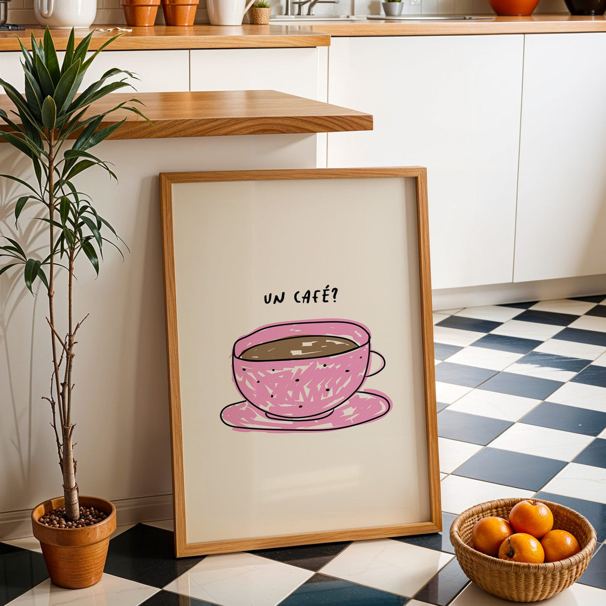 Un cafe pink cup print in an oak frame by a kitchen island and checkered floor