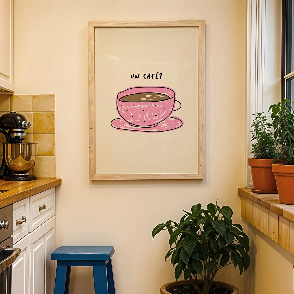 Un cafe pink cup print in a wood frame on a yellow tiled kitchen wall
