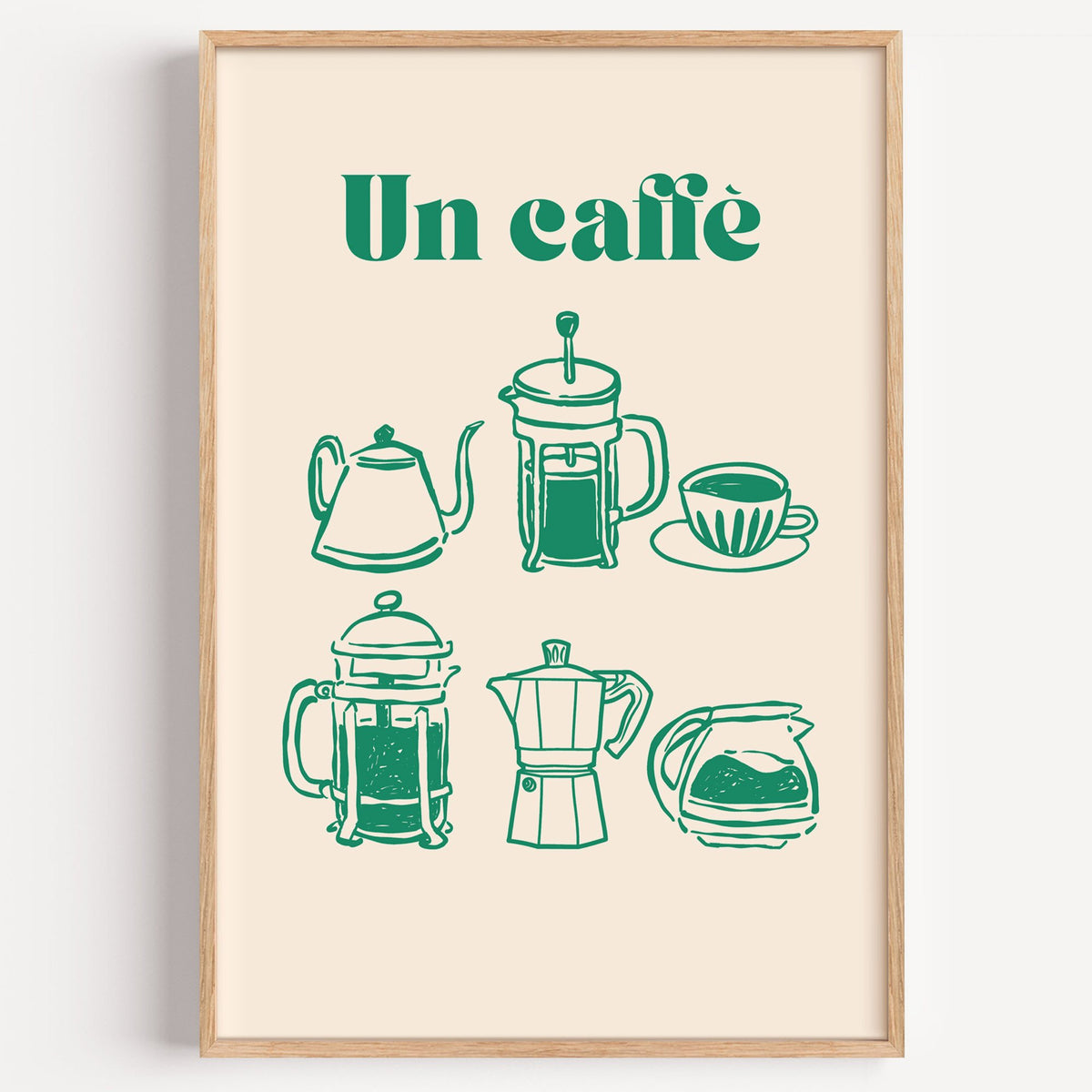 Un caffè green coffee makers print in a light oak frame on a plain white wall