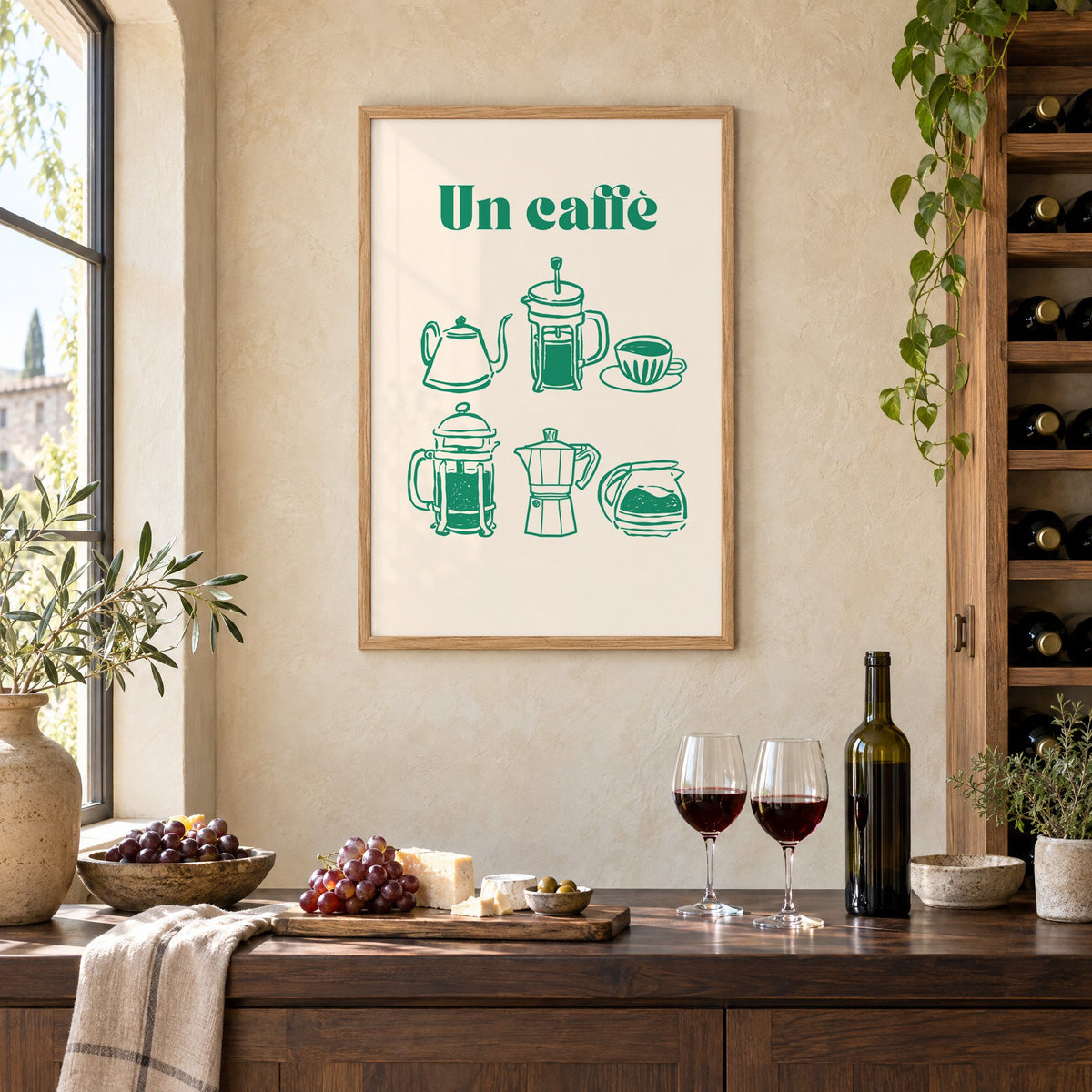 Un caffè green coffee makers print in an oak frame on a limewashed wall above a wine counter with red wine, cheese and grapes