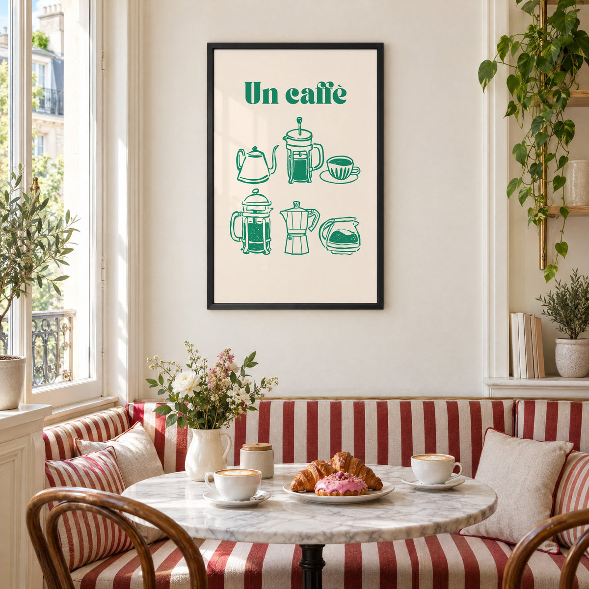 Un caffè green coffee makers print in a black frame above a striped cafe breakfast nook with cappuccino and pastries