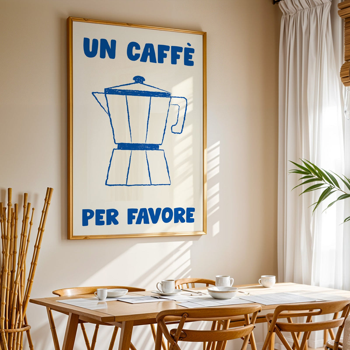 Un caffe per favore moka pot print in a gold frame above a sunlit breakfast table
