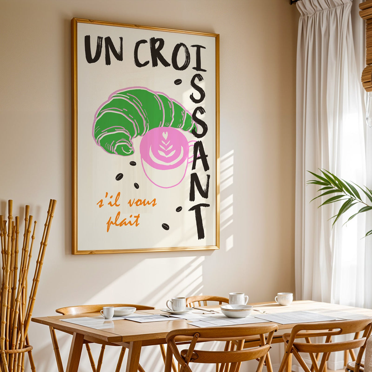 Un croissant french bakery print in a gold frame above a sunlit breakfast table