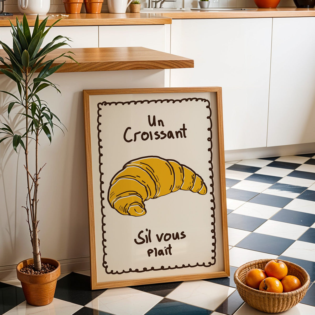 Un croissant yellow bakery print in an oak frame by a kitchen island