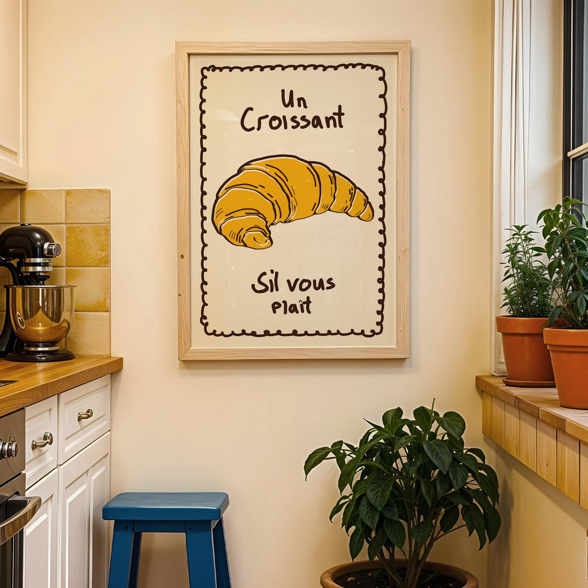 Un croissant yellow bakery print in a wood frame on a yellow tiled kitchen wall
