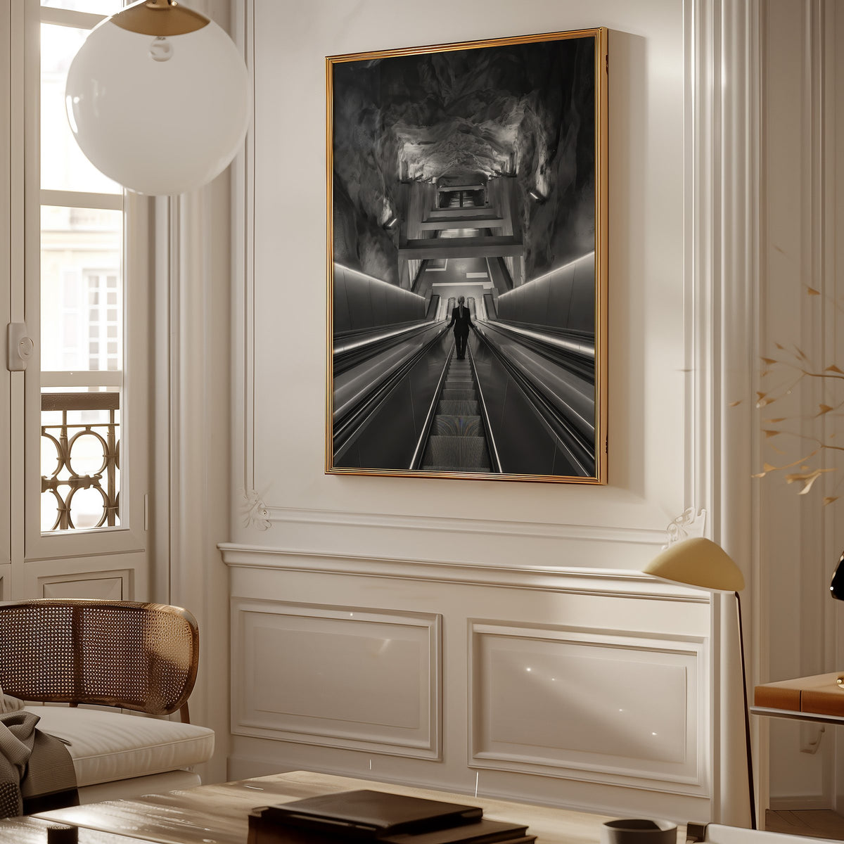 Black and white rock cave subway escalator print shown in a gold frame in a Parisian paneled living room