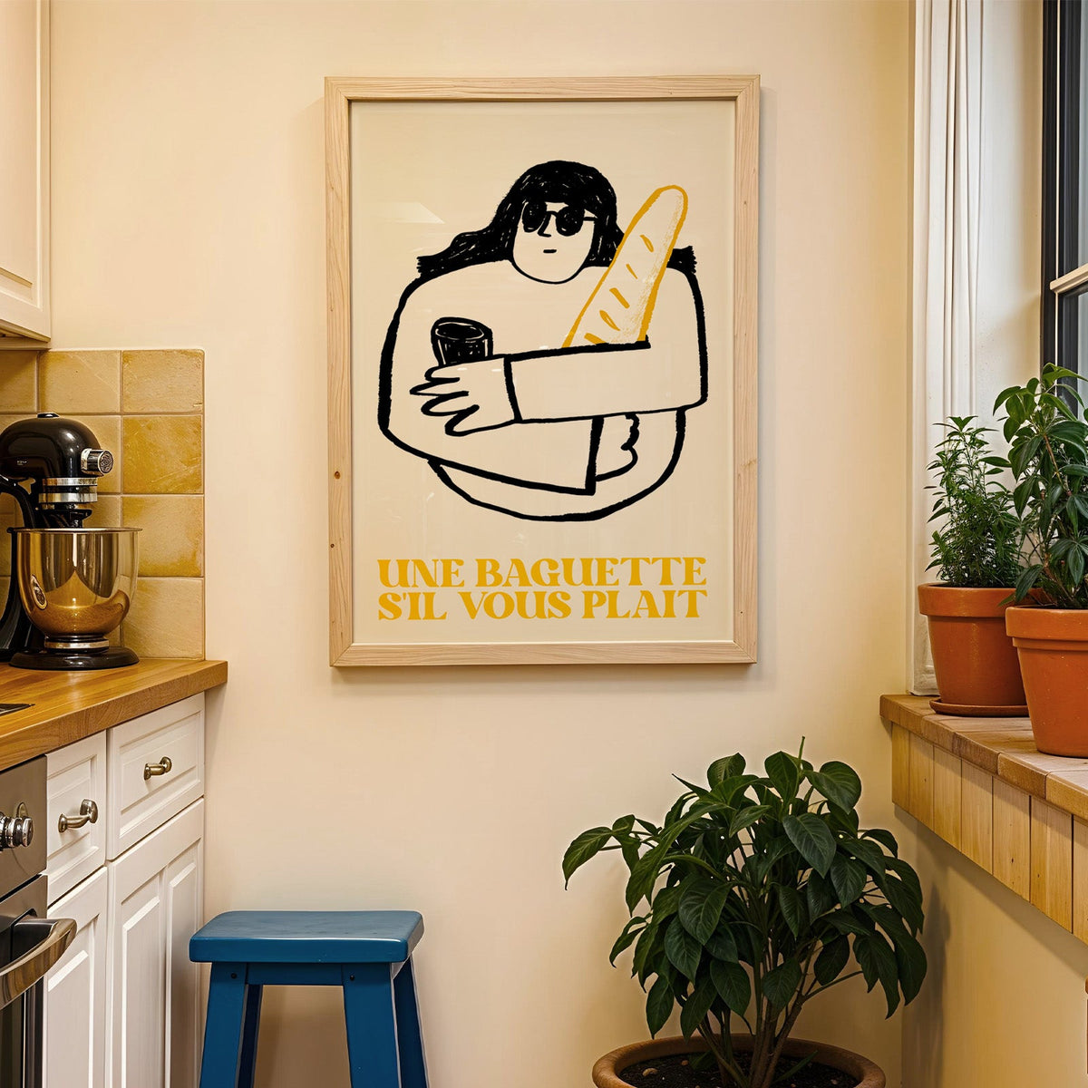 Une baguette french market print in a wood frame on a yellow tiled kitchen wall