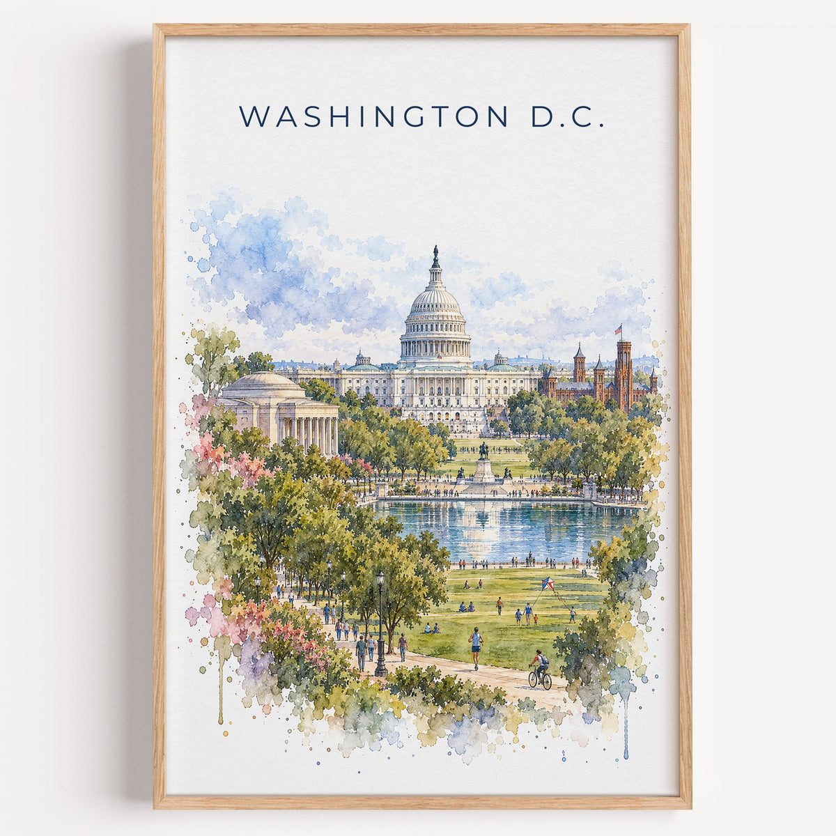 U.S. Capitol watercolor print in a light oak frame on a plain white wall