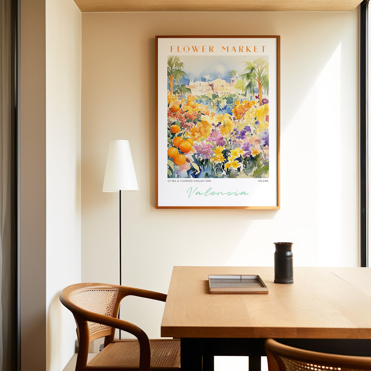 Valencia flower market print in an oak frame above a dining table and cane chair