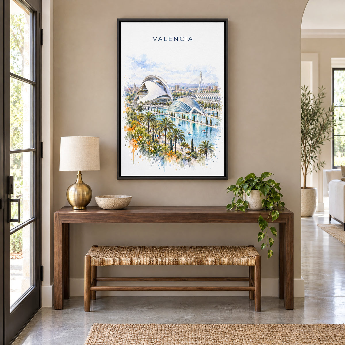 Valencia, Spain watercolor print as a black floater canvas above a walnut console and woven bench in an entryway