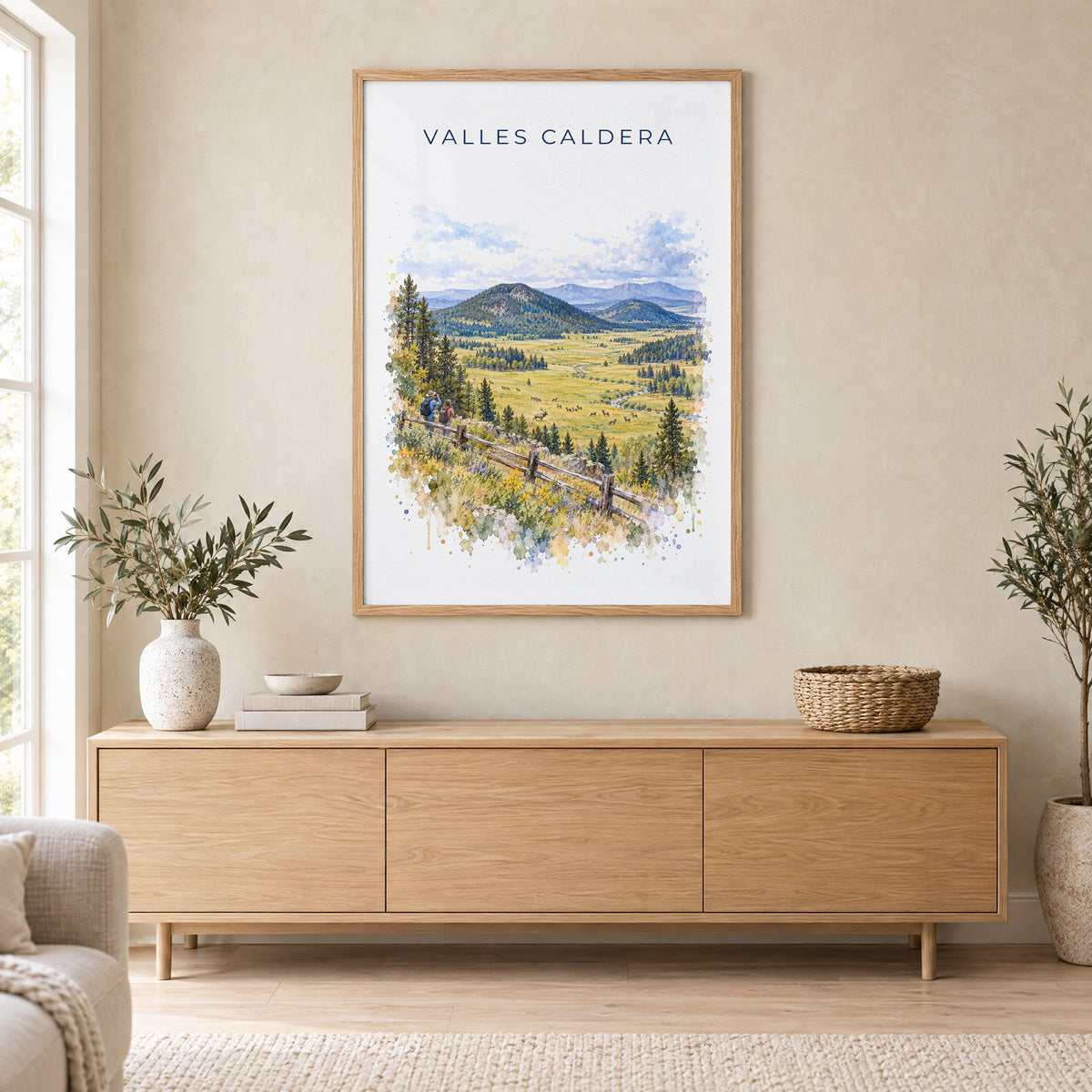 Valles Caldera National Preserve watercolor print in an oak frame above a light wood sideboard in a Scandinavian living room