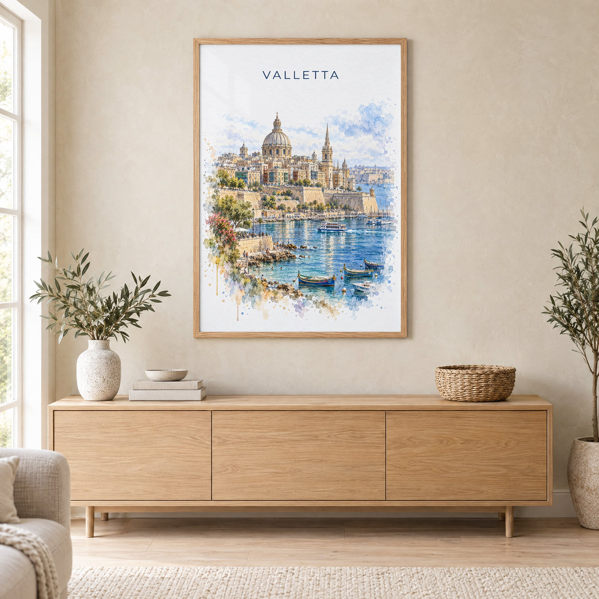 Valletta watercolor print in an oak frame above a light wood sideboard in a Scandinavian living room