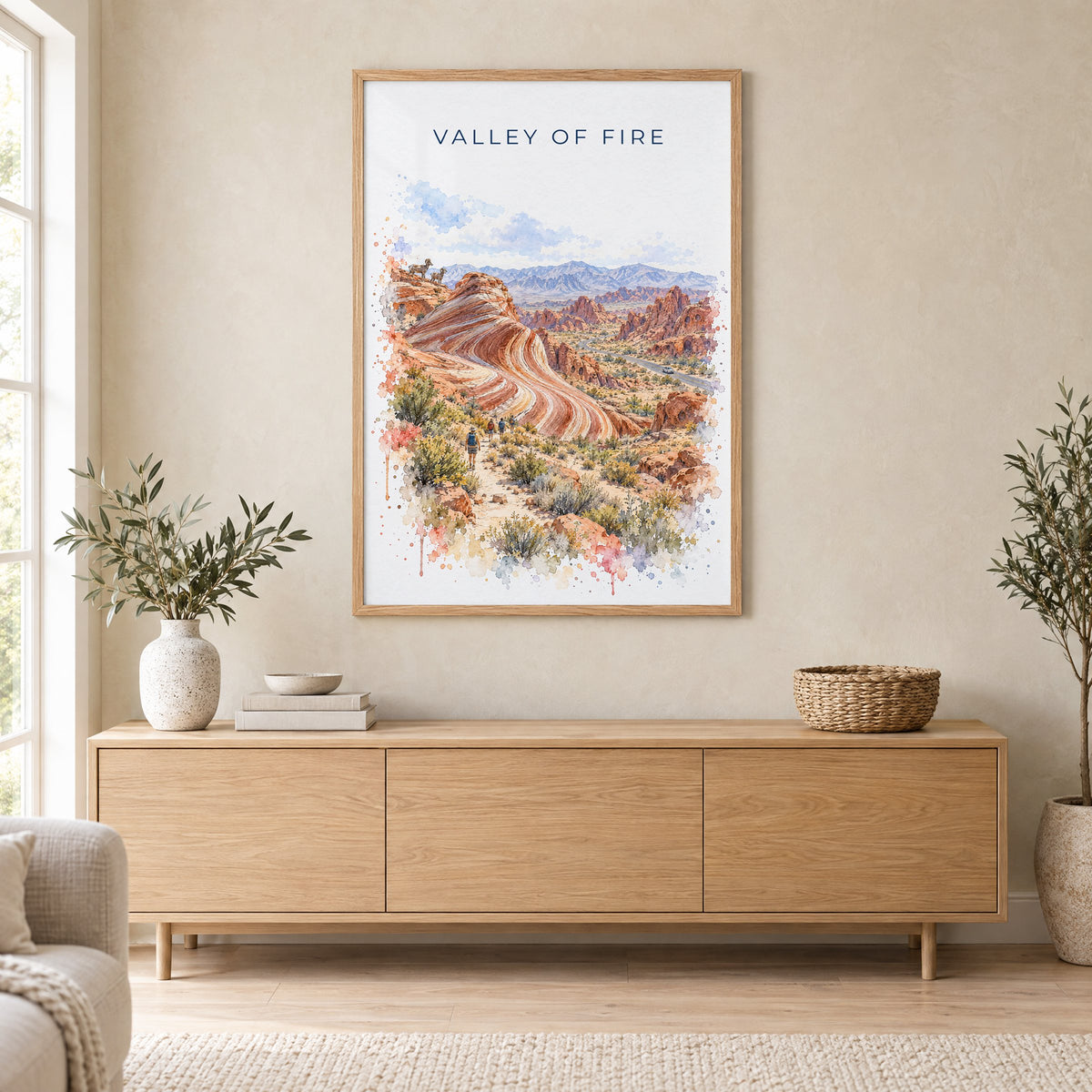 Valley of Fire watercolor print in an oak frame above a light wood sideboard in a Scandinavian living room