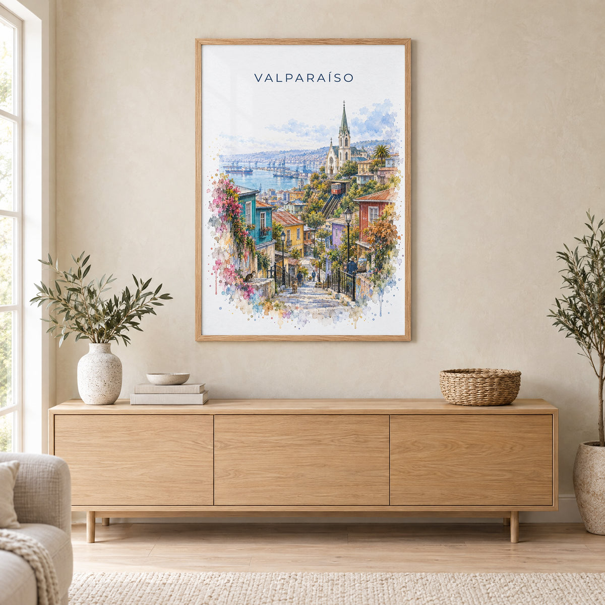Valparaíso watercolor print in an oak frame above a light wood sideboard in a Scandinavian living room