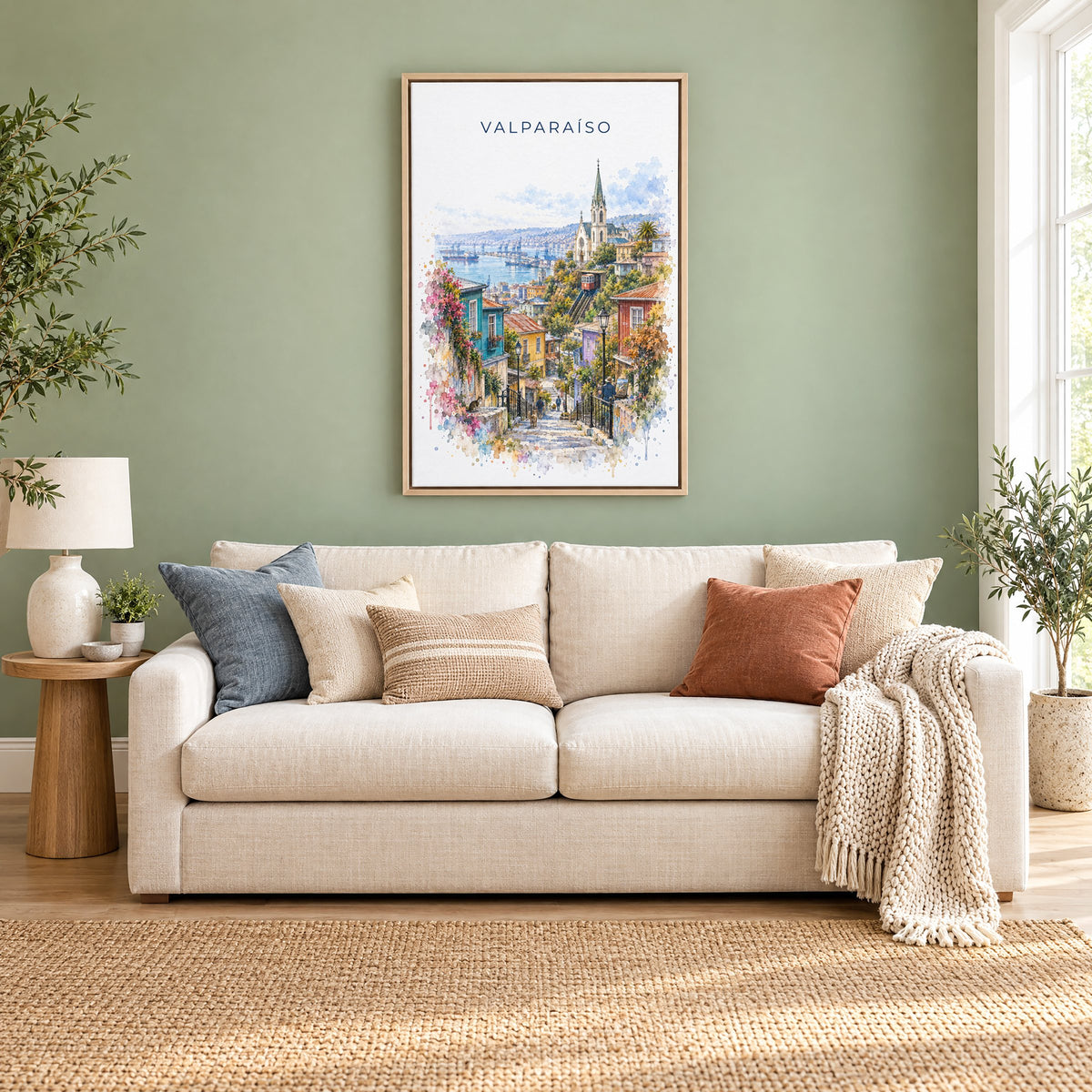 Valparaíso watercolor print as a natural floater canvas above a cream linen sofa on a sage green wall