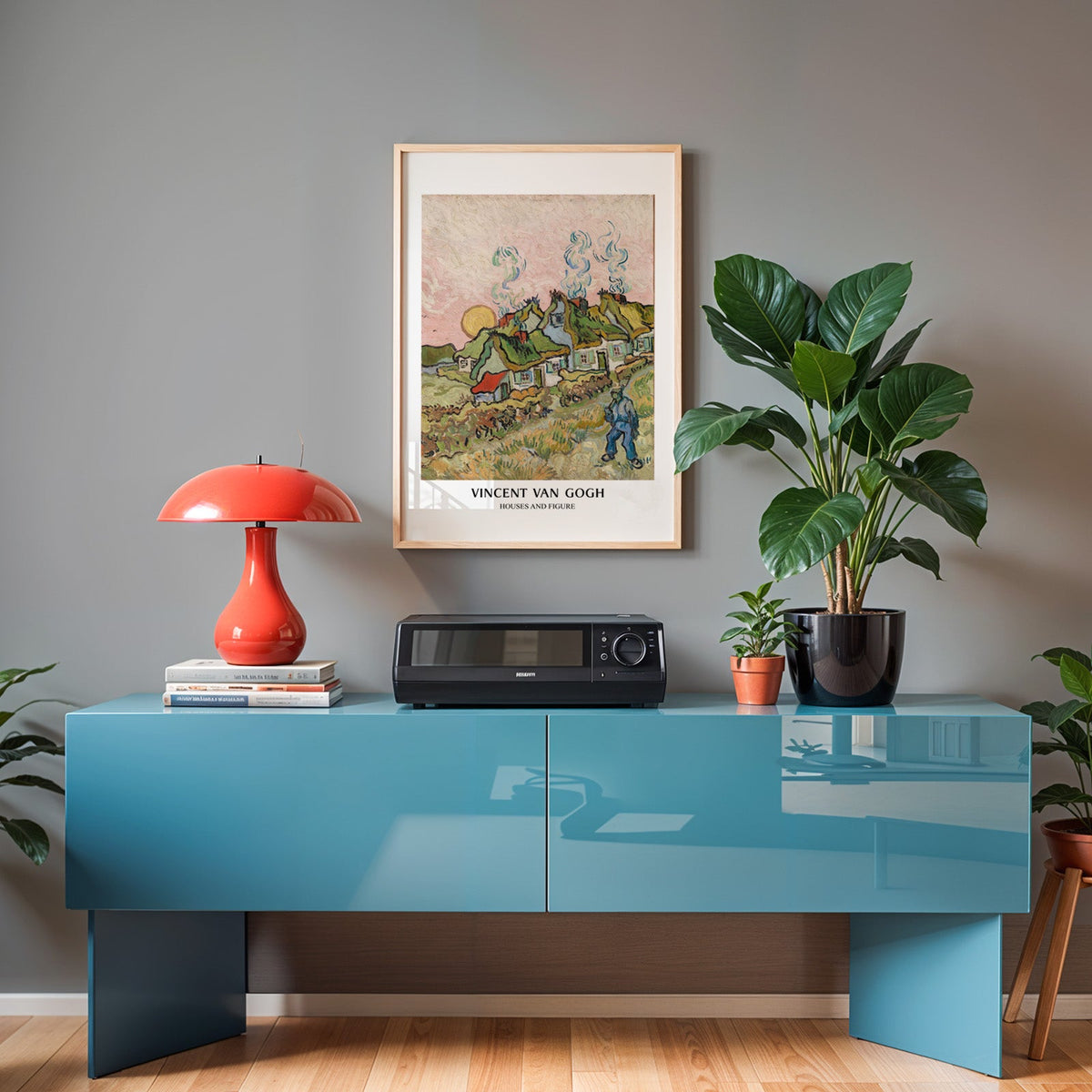 Van Gogh landscape poster in an oak frame above a teal sideboard with a red lamp