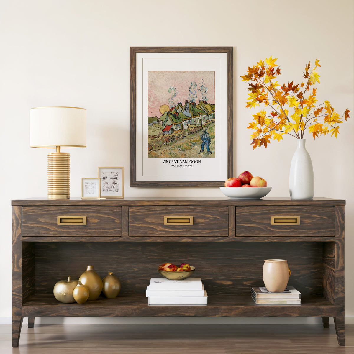 Houses and Figure print in a walnut frame above a console with autumn branches