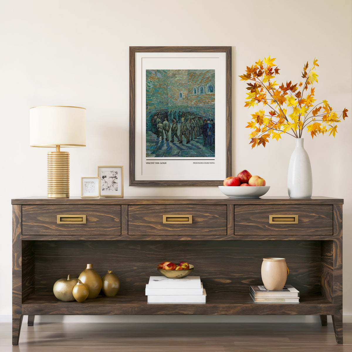 Prisoners Exercising print in a walnut frame above a console with autumn branches