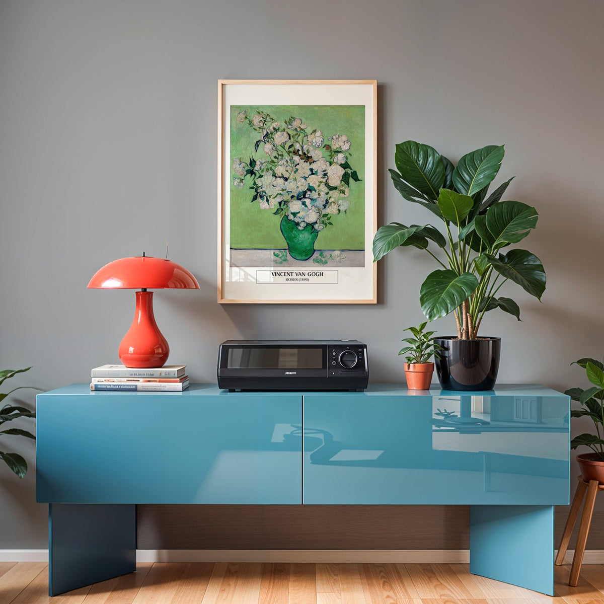 Van Gogh flower poster in an oak frame above a teal sideboard with a red lamp