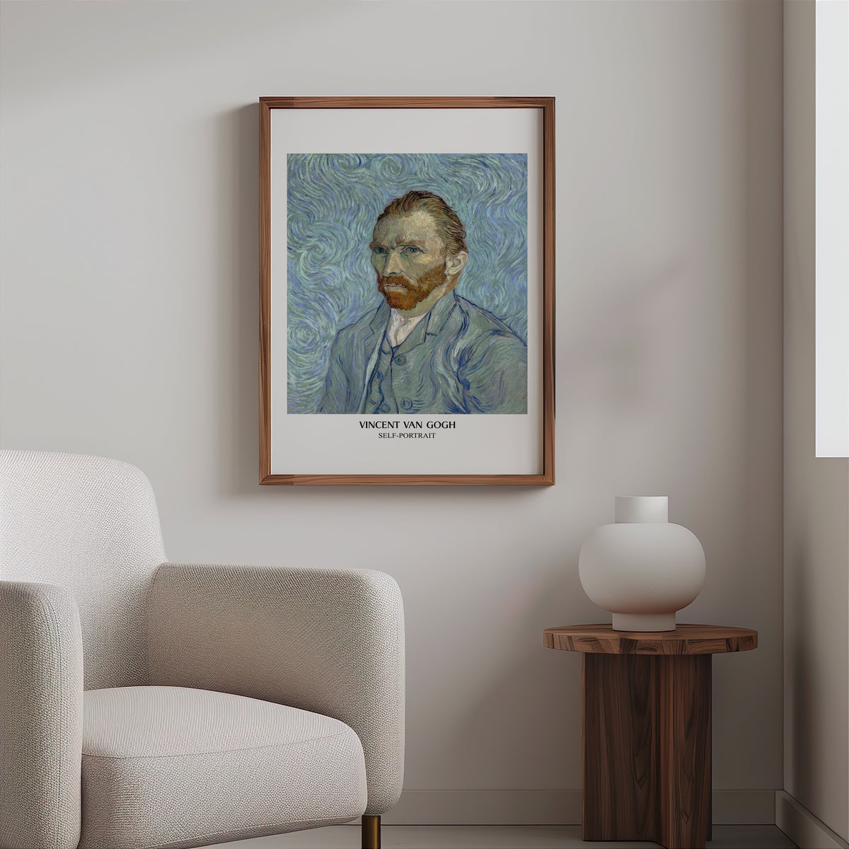 Van Gogh self-portrait print in a slim walnut frame above a bouclé armchair