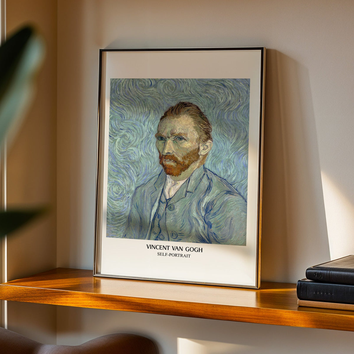 Van Gogh Self-Portrait print in a black frame on a walnut shelf in evening light