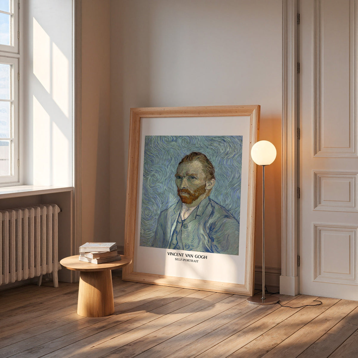 Van Gogh self-portrait print in a wide pine frame leaning by a sunlit window