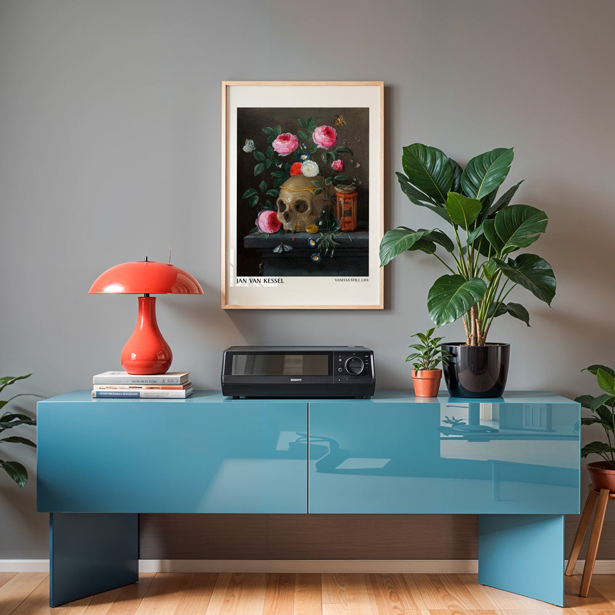 Van Kessel print in an oak frame above a teal sideboard with a red lamp