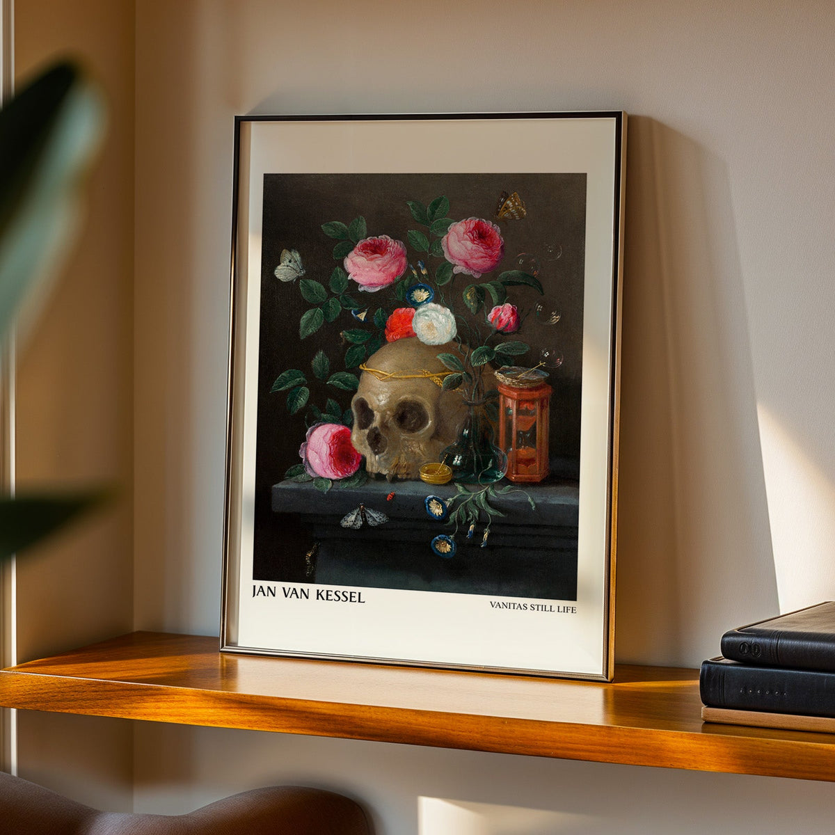 Baroque vanitas print in a black frame on a walnut shelf in evening light