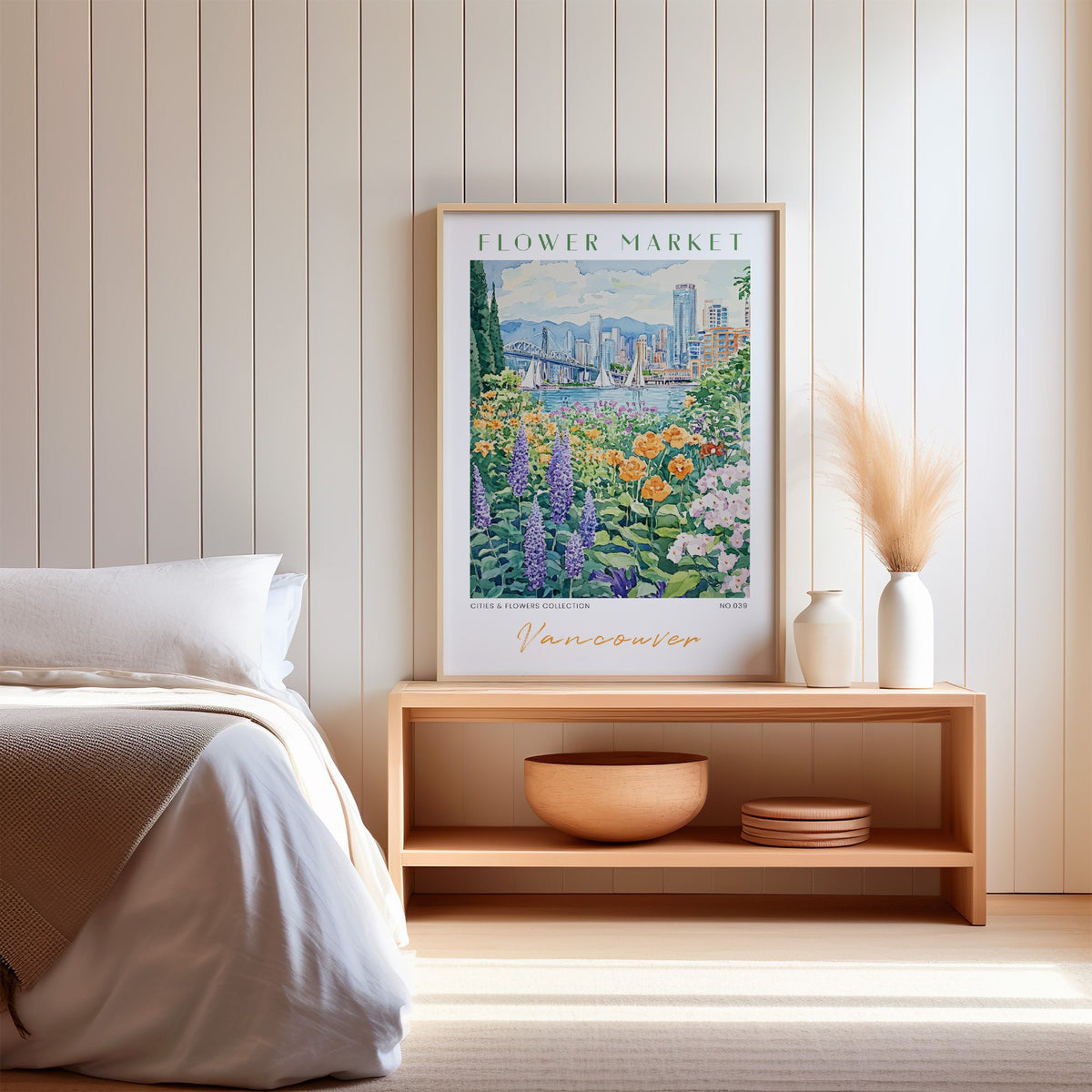 Vancouver flower market print in an oak frame on a wood bench against a white shiplap bedroom wall with pampas grass