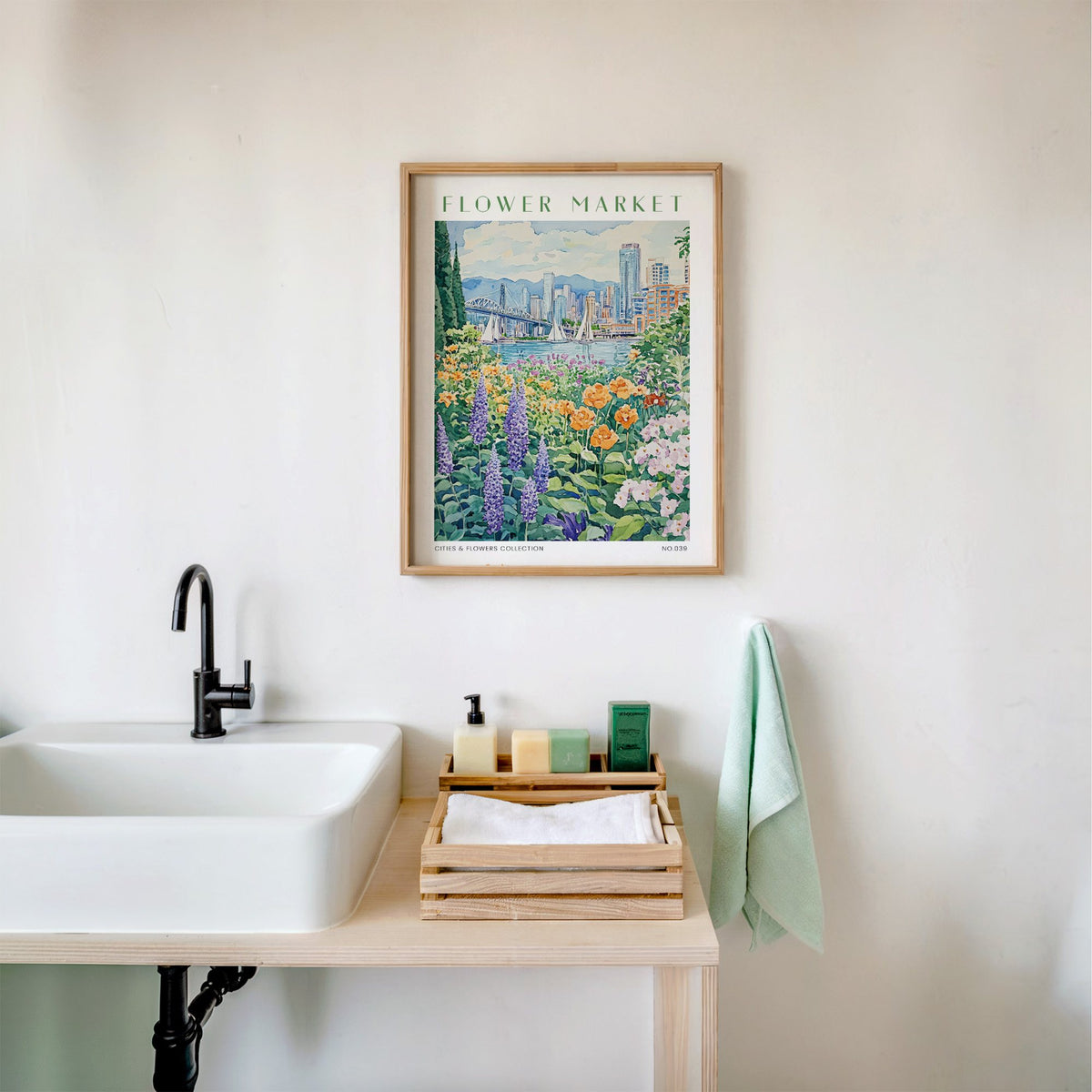 Vancouver flower market print in an oak frame above a white bathroom sink with folded towels